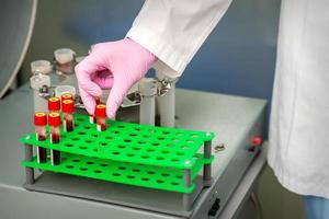 Medical technician taking blood sample photo