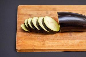 Eggplant on wooden cutting board photo