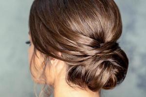 Brunette woman with middle bun hairstyle photo