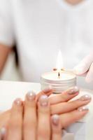 Manicure master is lighting candle photo