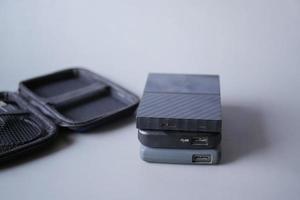 stack of external hard drives on table photo