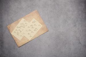 high angle view of question mark on paper on office desk photo