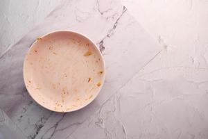 Empty plate after eating on table photo