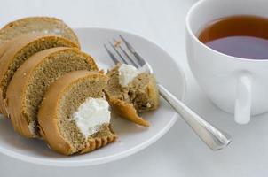 Coffee Cream Roll Cake with a Cup of Tea on Tea Breaking Time photo