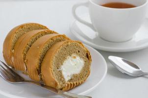 Coffee Cream Roll Cake with a Cup of Tea on Tea Breaking Time photo