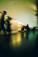 Motion blur image of a subway with moving people and a trai. photo