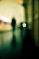 Motion blur image of a subway platform with human silhouettes. photo