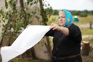 July 20, 2022 Belarus, the village of Lyaskovichi. Refugee camp.A woman in a refugee camp washes clothes. photo