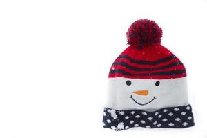 Knitted Christmas snowman hat on a white background. photo