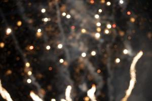 On a black background bokeh from explosions of colorful fireworks. photo