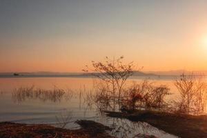 On the shore of the lake in the late afternoon photo