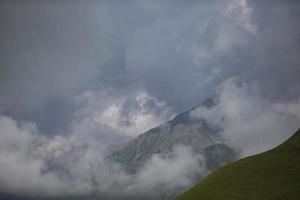 High mountains in low clouds. Mountain landscape. Mountains of Georgia. photo