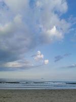 Sunset clouds over the sea beach photo