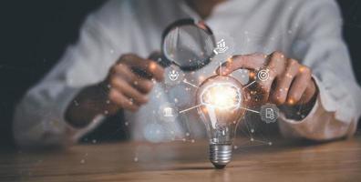 businessman pointing to a light bulb ,solution concept and demonstrating leadership strategies,that lead the business in a successful direction,with innovation and brain power from brainstorming photo