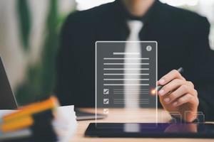 Businessman checking the steps through a virtual online document with a list of checkboxes Concepts of practices and policies, company articles of association Terms and Conditions ,legal contract photo