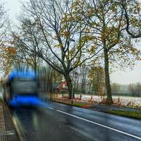 View of a bus arriving to bus stop in Winter photo