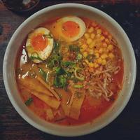 Japanese ramen noodle soup with egg and vegetables on a wooden table photo