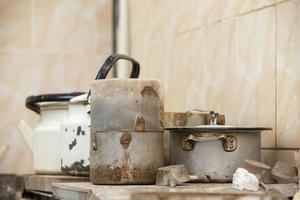 Old dirty rusty crockery pots and kettles. photo