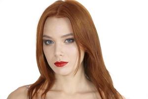 Portrait of a beautiful red-haired girl on a white background. photo