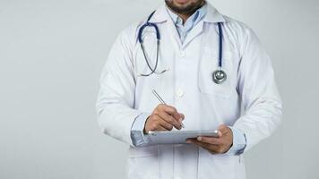 male doctor is holding stethoscope into the camera photo