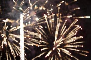 On a black background bokeh from explosions of colorful fireworks. photo