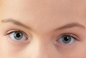 Close-up of baby's blue eyes. Human eye with eyebrows. photo