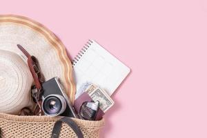 Traveler accessories, beach hat with retro film camera, sunglasses, money and passport photo