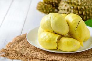 Fresh durian monthong on white dish and white wood background, photo