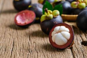 Fresh Mangosteen on old wood baclground. Mangosteen has been known as The Queen of Fruits, photo