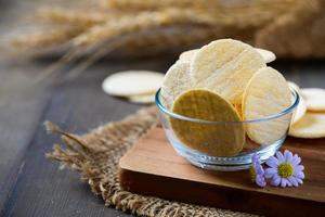 Round Crackers biscuits in glass cup and wood background, snack and fast food concept photo