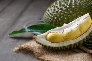Puangmanee durian on wood plate and wood background, It's a small durian. photo