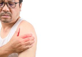 A middle aged man in white veat suffering from arm and shoulder pain isolated on white. photo