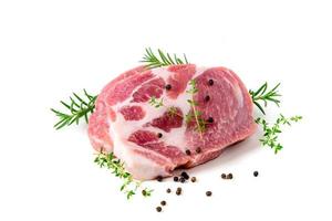 Pieces of pork meat with rosemary and thyme leaves on isolated on white background, photo