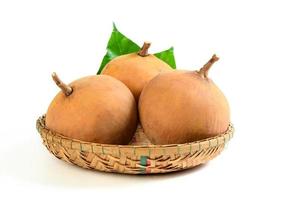 santol fruit in bamboo basket and isolated on white background, photo