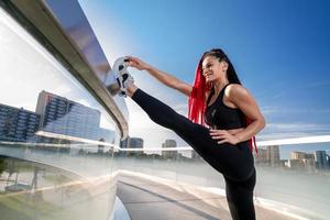 Fitness, exercise and a woman stretching at gym during warm up workout and training for health and wellness. Sports female or athlete on ground to stretch legs to be flexible, balance and healthy photo