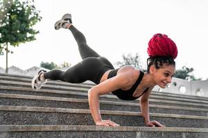 Fitness, gym and workout of a woman doing plank exercise or training for wellness with focus for healthy lifestyle. Female athlete with body weight routine for strong core, sports health and balance