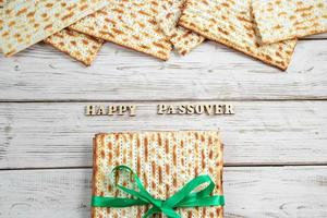 Concept of Jewish holiday Pesach. Passover. Traditional matzah on a white wooden background. Matzo bread. photo