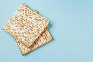 Happy Passover banner. Matzo on a blue background. Traditional Jewish food for Pesach. Copy space. photo