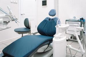 Close-up of dental equipment in dentistry clinic. Workplace and tools of dentists. Dental chair and surgical instruments photo