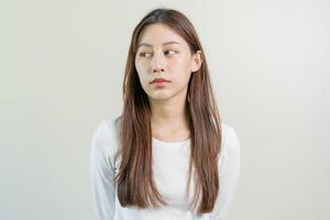 Depressed, distracted asian young woman in casual tired stressed with problem, portrait of brunette with long hair, feeling sad lonely, standing alone avoid looking, isolated on white background. photo