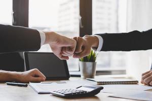 Congrats, business partnership people, two asian and caucasian young man fist bumping, shaking hands together with partnership, customer or colleague after work is done, successful. Worker meeting. photo