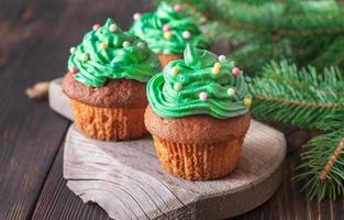 Decorated cupcakes with Christmas tree branch photo