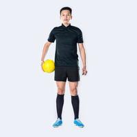 soccer referee holding whistle and holding ball isolated. photo