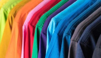Colorful t-shirts hanging on a rack photo