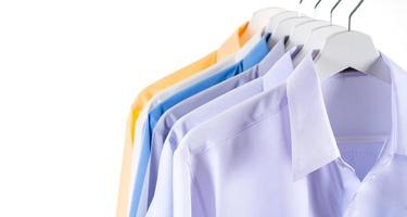 Colorful shirts hanging on a rack photo