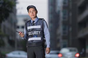 Male security guard using portable radio