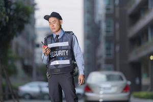 Male security guard using portable radio photo