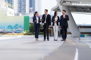 Business people walking and talk to each other in front of modern office photo