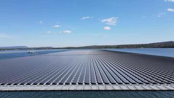 Aerial top view of solar panels or solar cells on buoy floating in lake sea or ocean. video