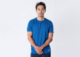 Elegant young man in blue shirt standing on white background photo